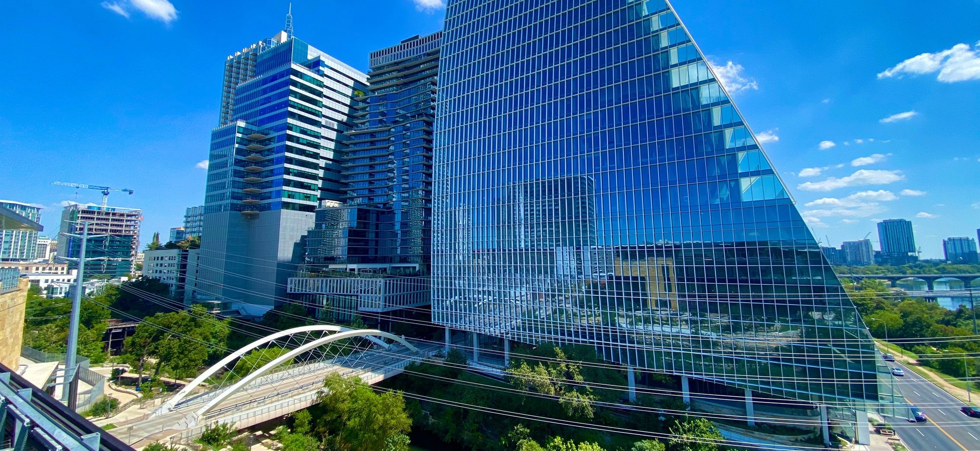 Austin downtown buildings under puffy clouds and a blue sky, high tech skyscrapers-1 Austin downtown buildings under puffy clouds and a blue sky, high tech skyscrapers-1